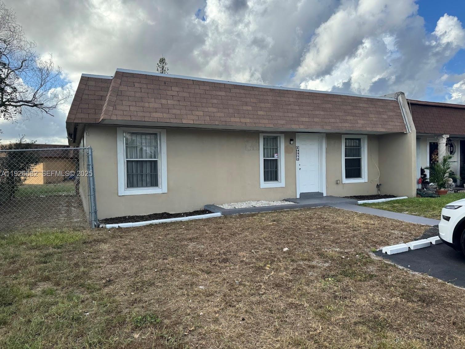 19354 Northwest 28th Court, Unit 19354 Miami Gardens, FL 33056 - Photo 16 of 17 a backyard of a house