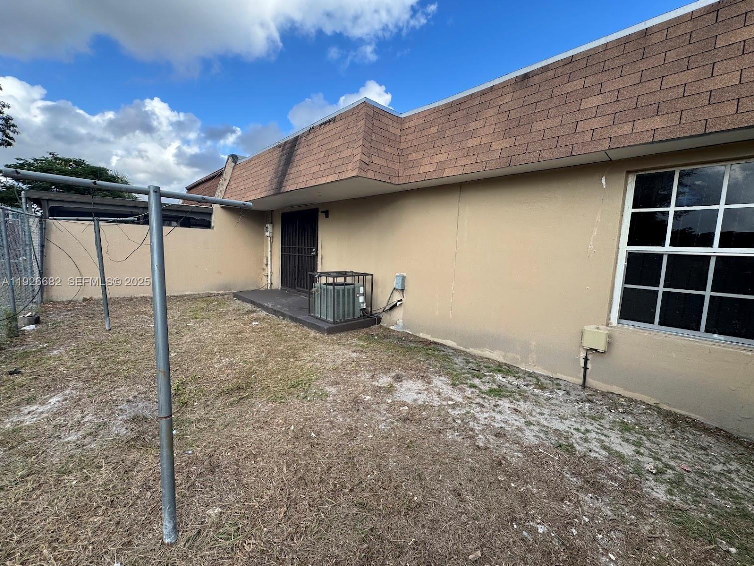 19354 Northwest 28th Court, Unit 19354 Miami Gardens, FL 33056 - Photo 17 of 17 a house view with a backyard space