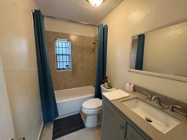 a bathroom with a sink a toilet and tub