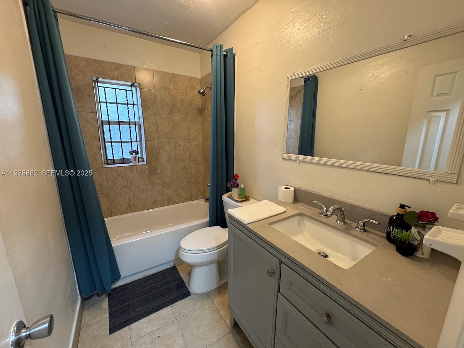 19354 Northwest 28th Court, Unit 19354 Miami Gardens, FL 33056 - Photo 10 of 17 a bathroom with a sink a toilet a mirror and shower