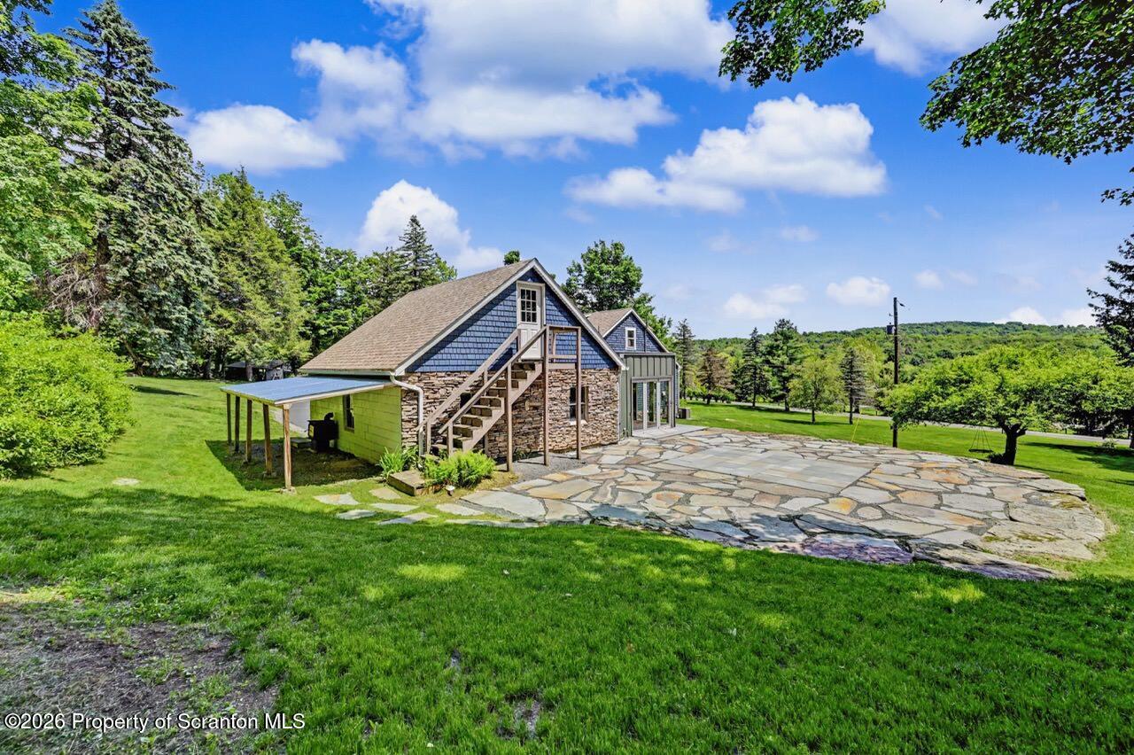 457 Craig Road Dalton, PA 18414 - Photo 105 of 114 a view of a house with a big yard and potted plants