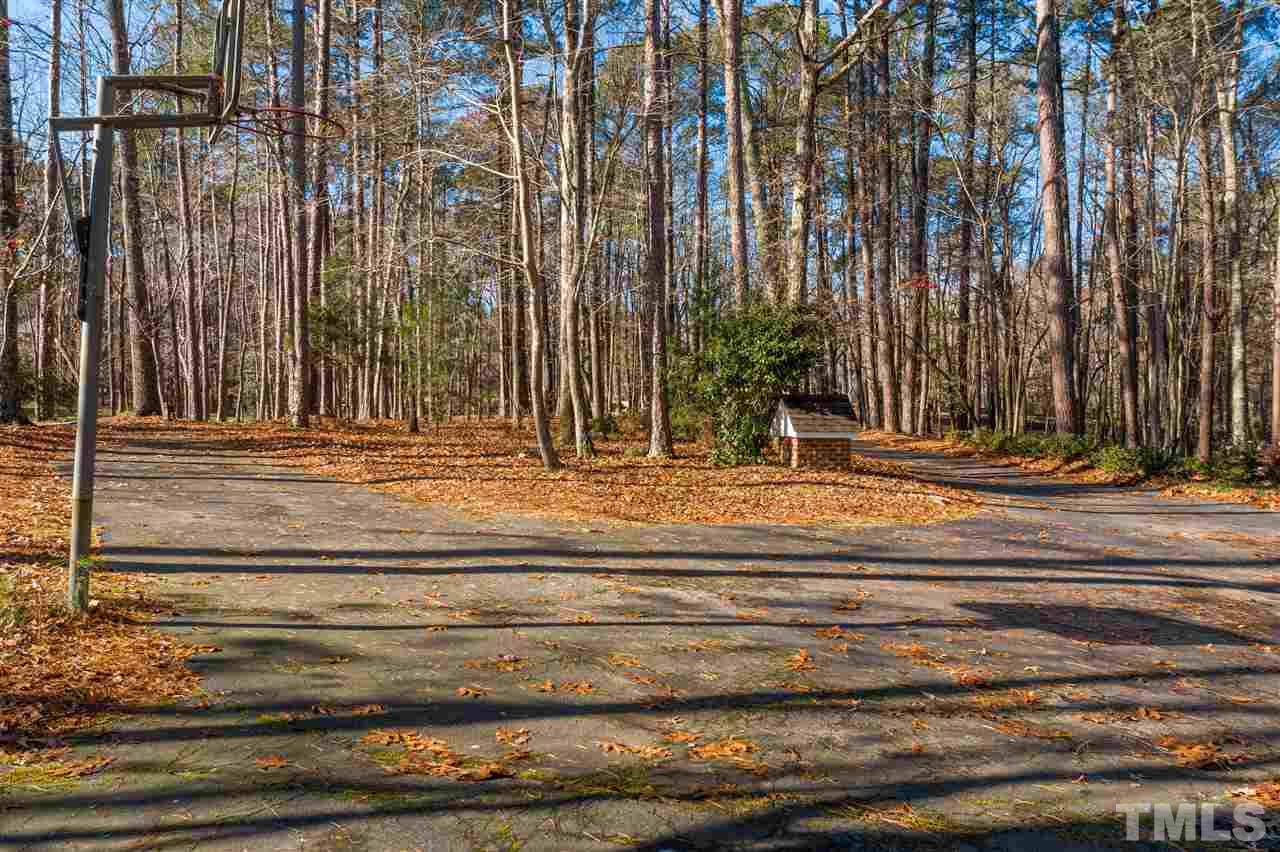 8528 Bournemouth Drive Raleigh, NC 27615 - Photo 4 of 30 A very long and partially circular drive winds its way along the wooded lot to the front of this charming home.