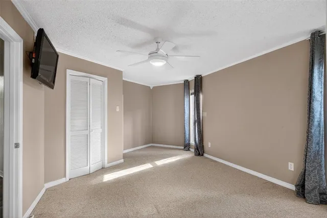 a view of a livingroom with an empty space and a ceiling fan