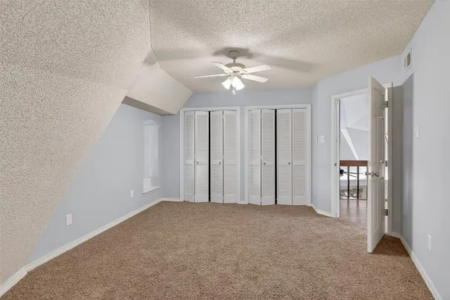 a view of an empty room with a fan