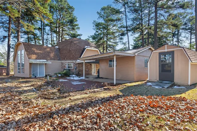 a view of a house with a yard covered with snow in the background