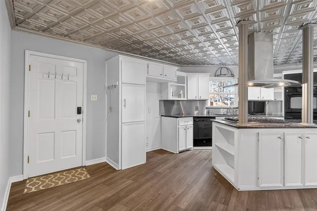 a kitchen with stainless steel appliances granite countertop a refrigerator and a stove