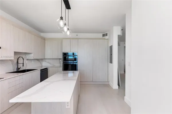 a kitchen with stainless steel appliances a refrigerator sink and stove