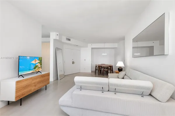 a bedroom with furniture and a flat screen tv