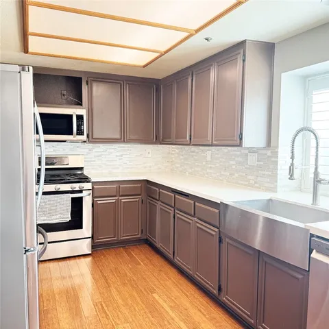 a kitchen with stainless steel appliances granite countertop a stove and a sink
