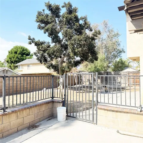 a view of a balcony with a floor to ceiling window and wooden fence
