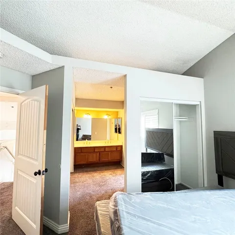 a bedroom with a bed and a view of bathroom