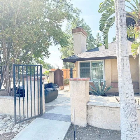 a view of a house with backyard and sitting area