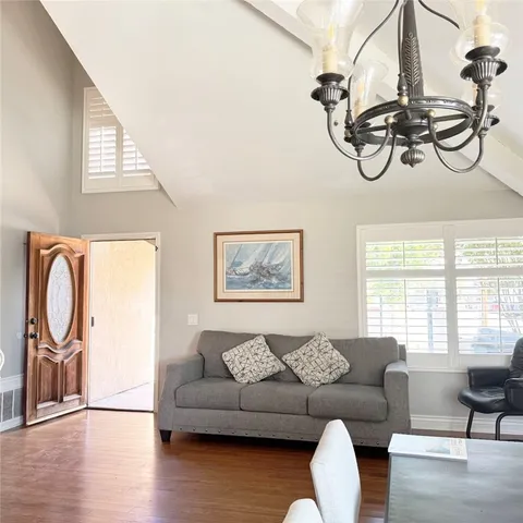 a living room with furniture a window and wooden floor