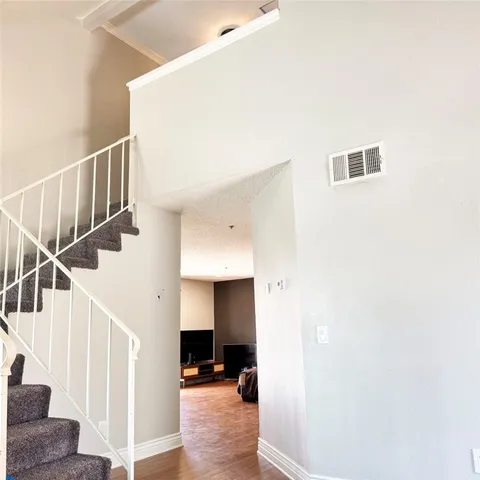 a view of entryway and hall with wooden floor