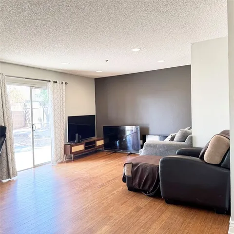 a bedroom with furniture and a flat screen tv