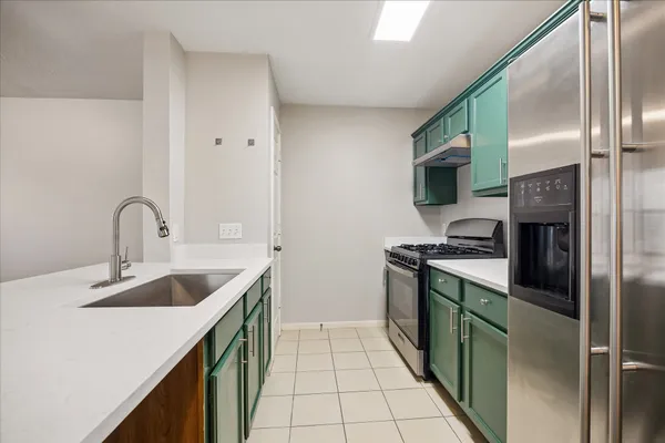 a view of a kitchen with wooden floor and a sink