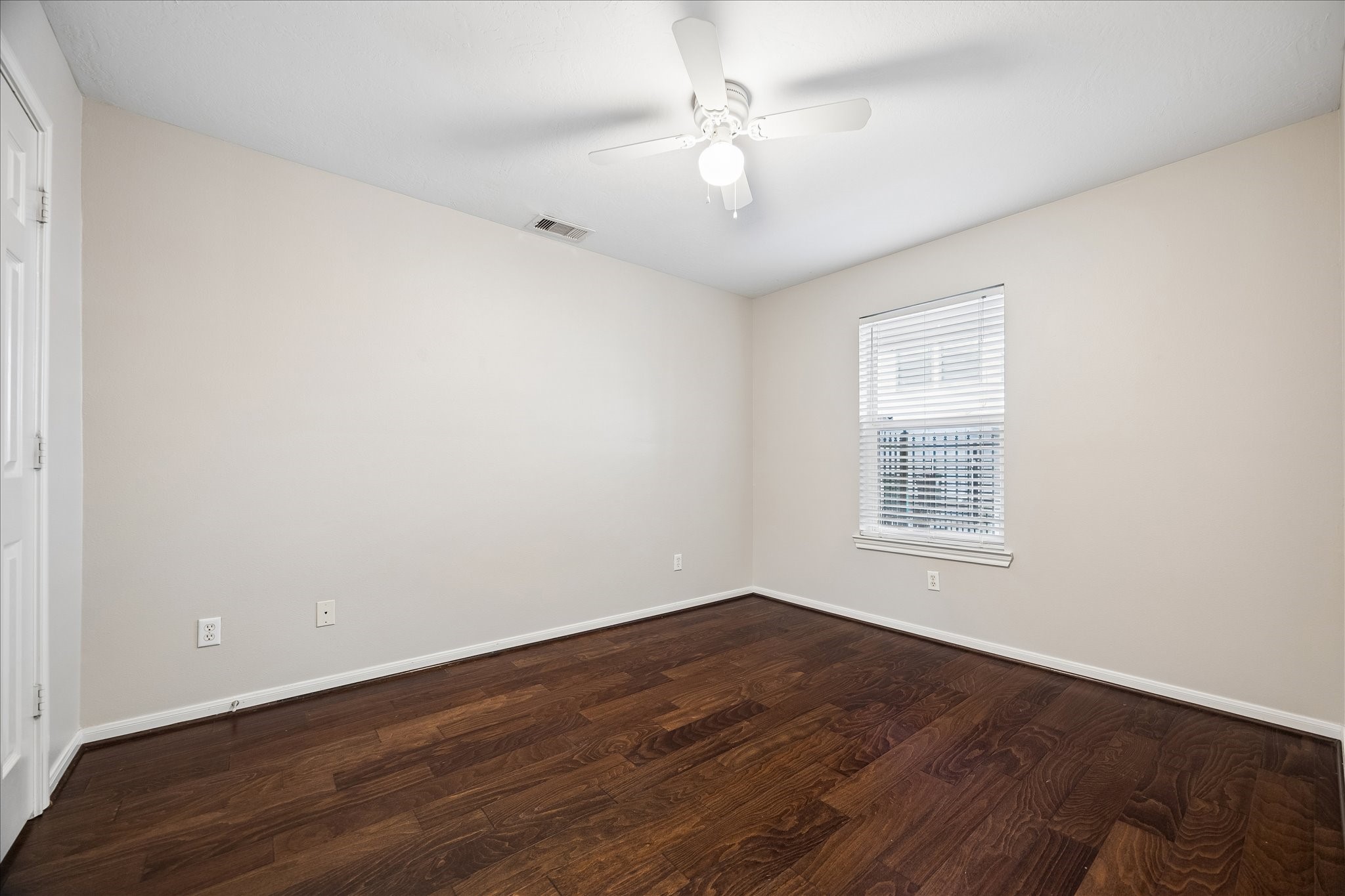 1510 Robin Street, Unit A Houston, TX 77019 - Photo 12 of 17 an empty room with wooden floor and window