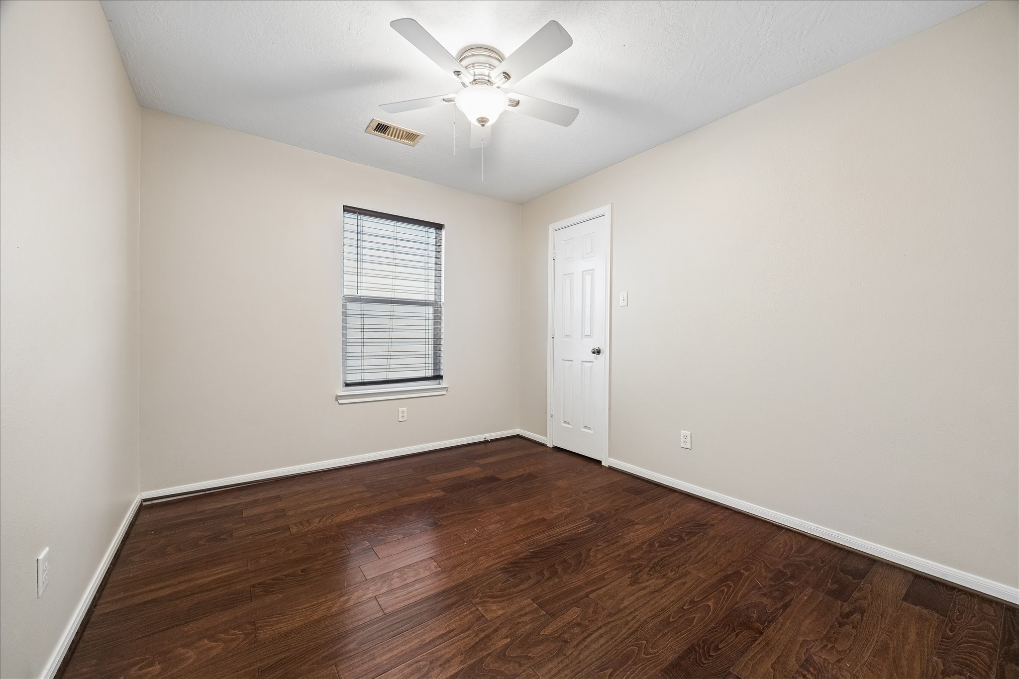 1510 Robin Street, Unit A Houston, TX 77019 - Photo 5 of 17 wooden floor in an empty room with a window