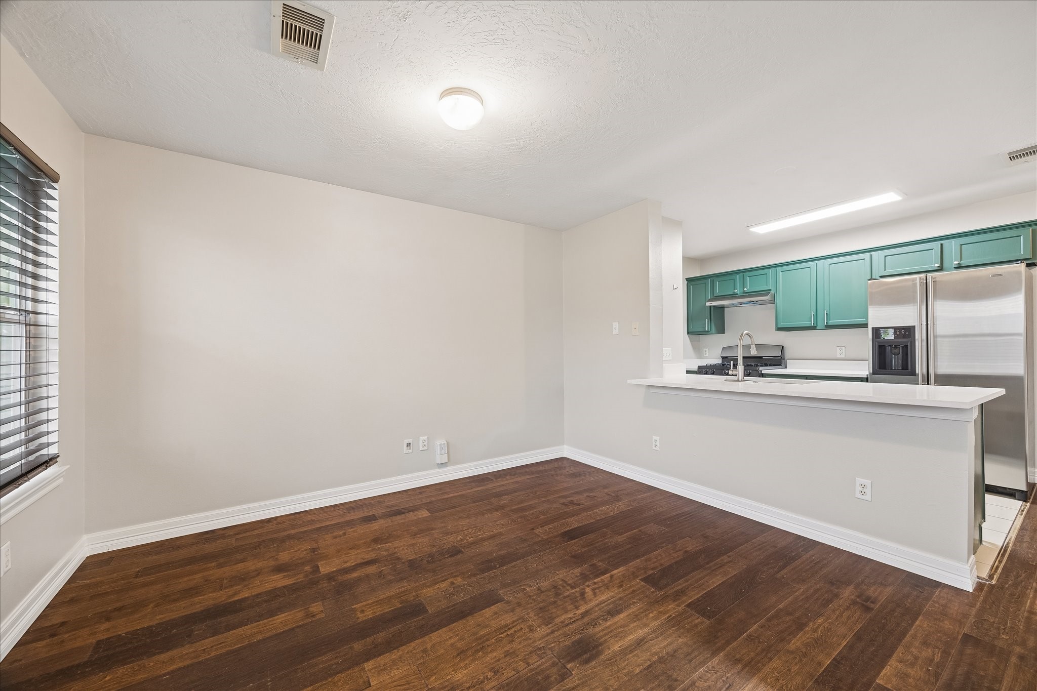 1510 Robin Street, Unit A Houston, TX 77019 - Photo 9 of 17 a view of a kitchen with wooden floor and a sink