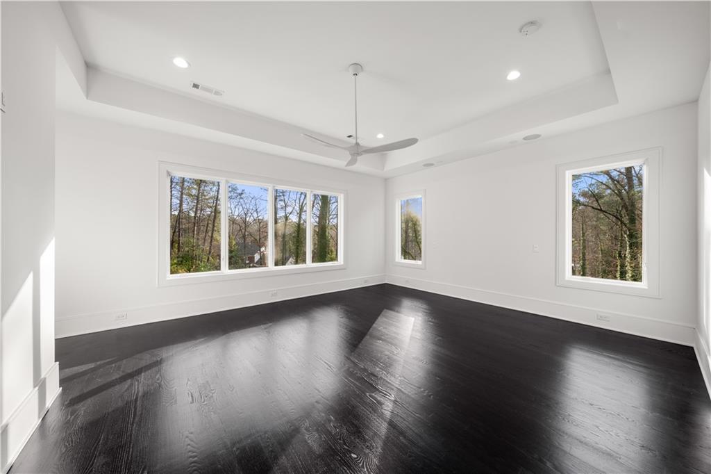 5211 Powers Ferry Road Northwest Sandy Springs, GA 30327 - Photo 89 of 106 an empty room with wooden floor and windows
