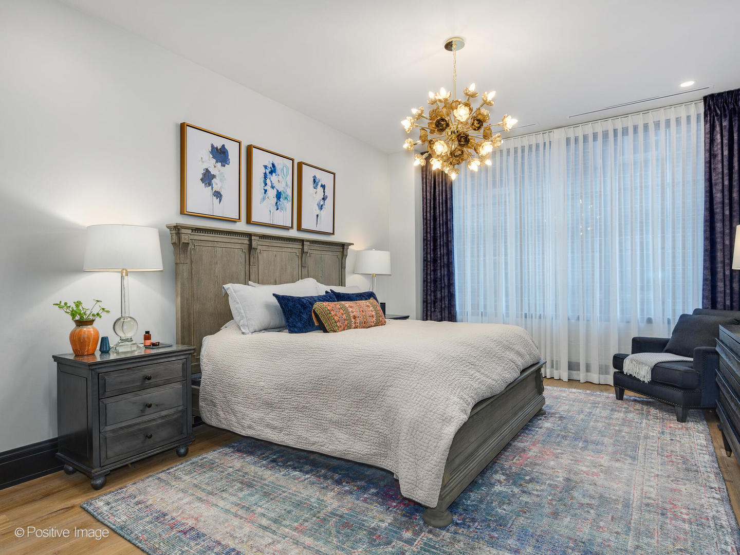 1109 West Washington Boulevard, Unit 2C Chicago, IL 60607 - Photo 28 of 40 a bedroom with a bed and a chandelier