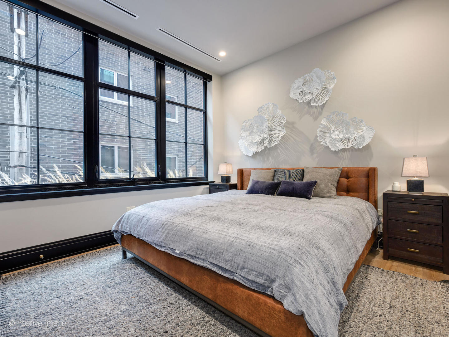 1109 West Washington Boulevard, Unit 2C Chicago, IL 60607 - Photo 36 of 40 a bed sitting in a spacious bedroom next to a window