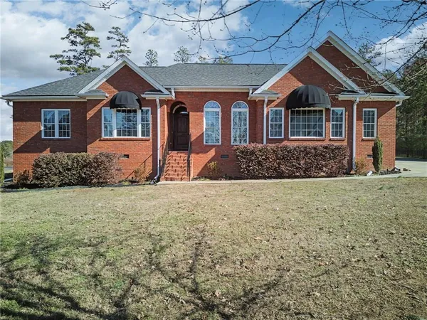 a front view of a house with garden