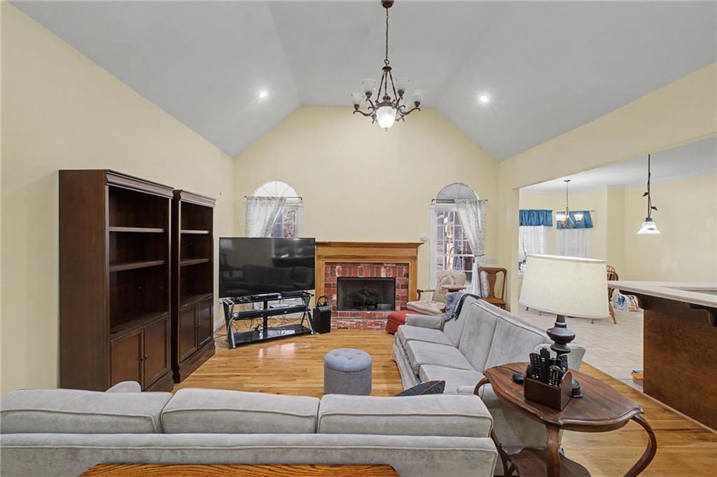 15 County Road 396 Centre, AL 35960 - Photo 13 of 54 a living room with furniture a fireplace and a chandelier