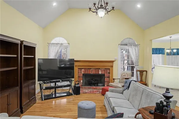 a living room with furniture a fireplace and a flat screen tv