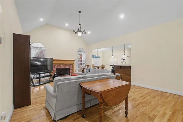 a dining hall with stainless steel appliances a dining table and chairs with wooden floor