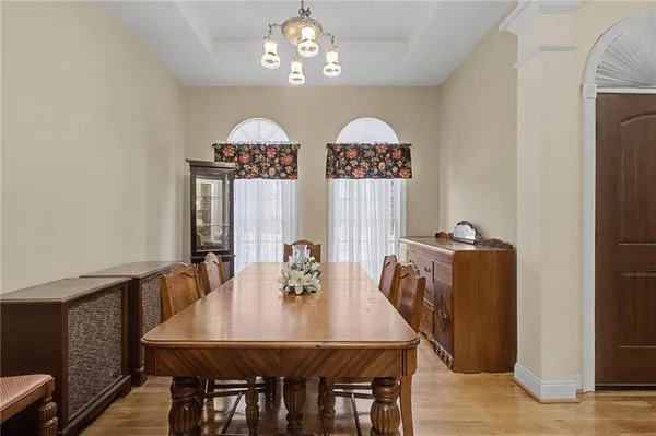 a view of a dining room with furniture and chandelier