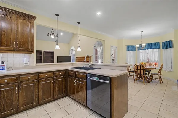 a kitchen with a sink counter and chairs