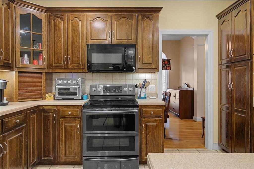 15 County Road 396 Centre, AL 35960 - Photo 30 of 54 a kitchen with stainless steel appliances wooden cabinets and a stove top oven