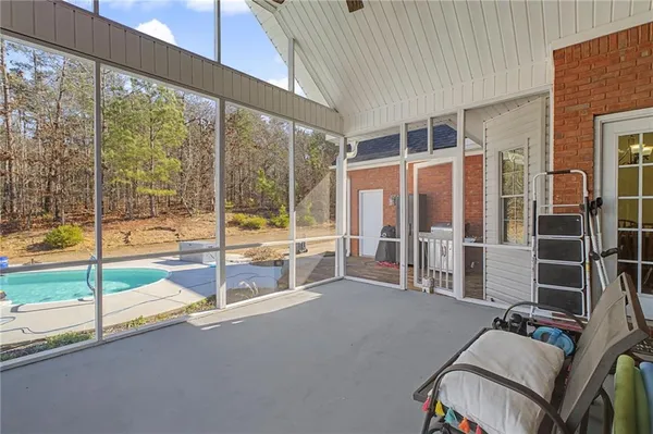 a view of a house with swimming pool and sitting area