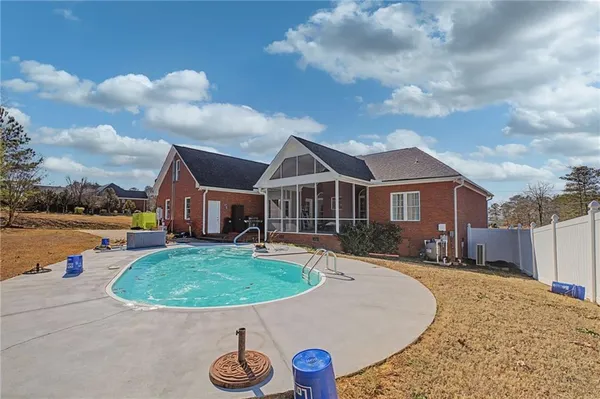 a view of a swimming pool with a yard