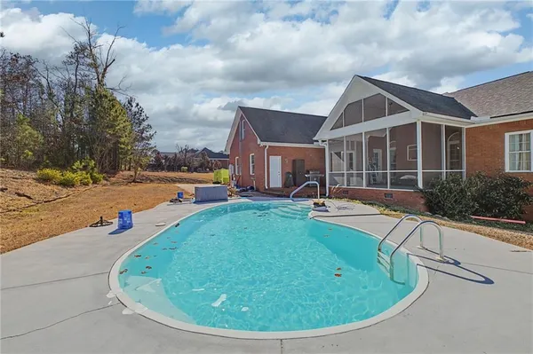 a view of a swimming pool with a yard