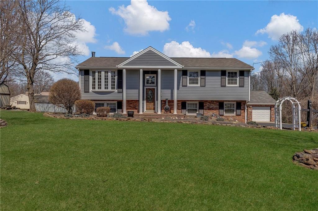 4930 Dutch Ridge Road Brighton Township, PA 15009 - Photo 1 of 25 a front view of a house with a garden and trees