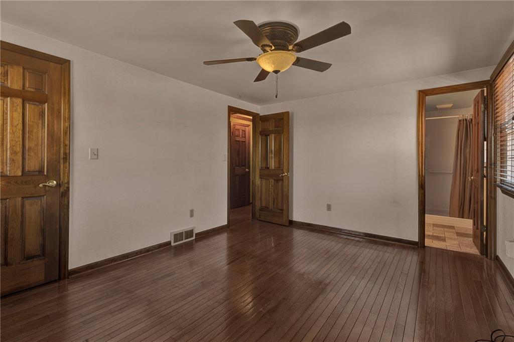 4930 Dutch Ridge Road Brighton Township, PA 15009 - Photo 14 of 25 an empty room with wooden floor and a ceiling fan