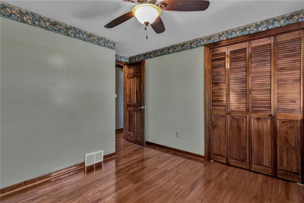 4930 Dutch Ridge Road Brighton Township, PA 15009 - Photo 16 of 25 a view of an empty room with wooden floor and a window