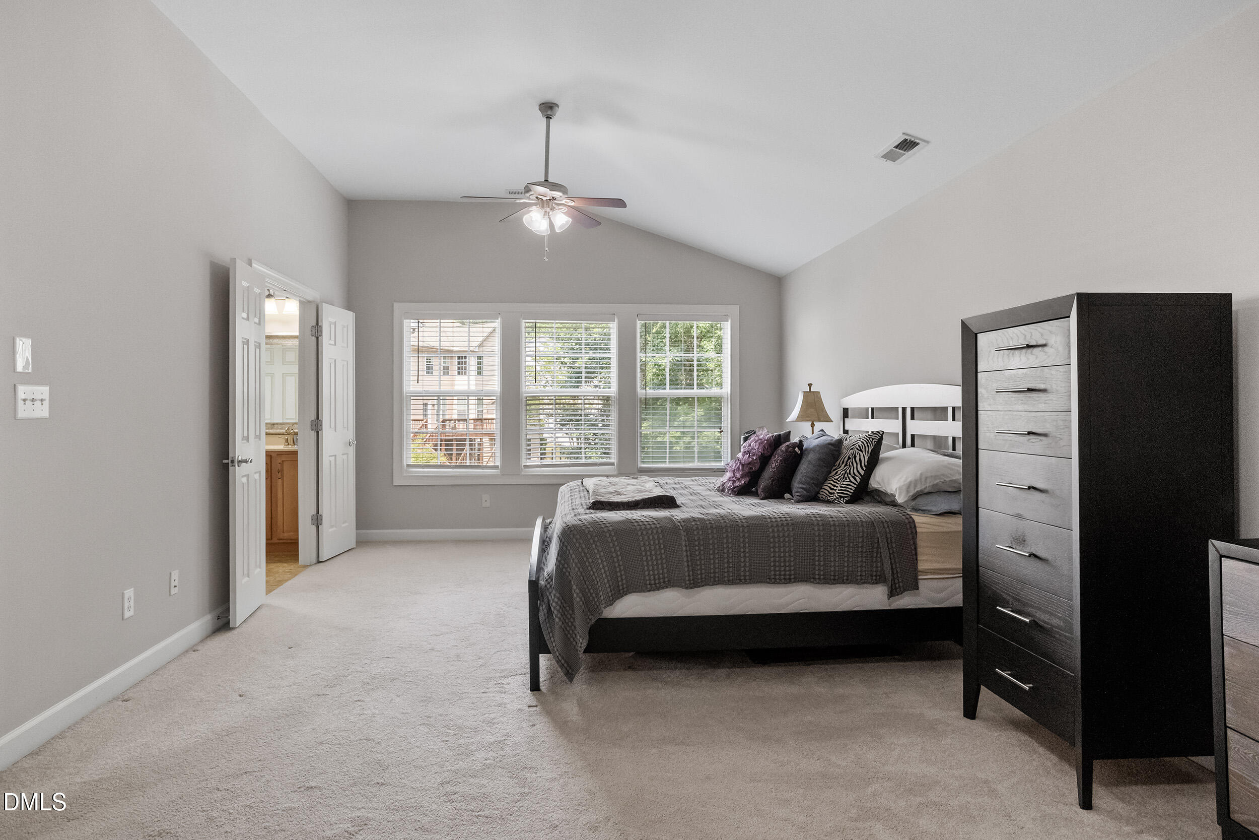 1019 Bianco Drive Raleigh, NC 27607 - Photo 20 of 29 a spacious bedroom with a bed and a chandelier
