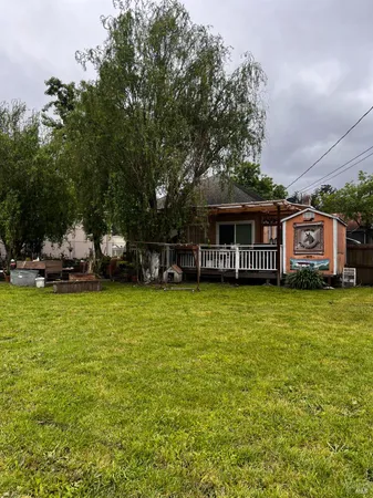 a front view of a house with a garden