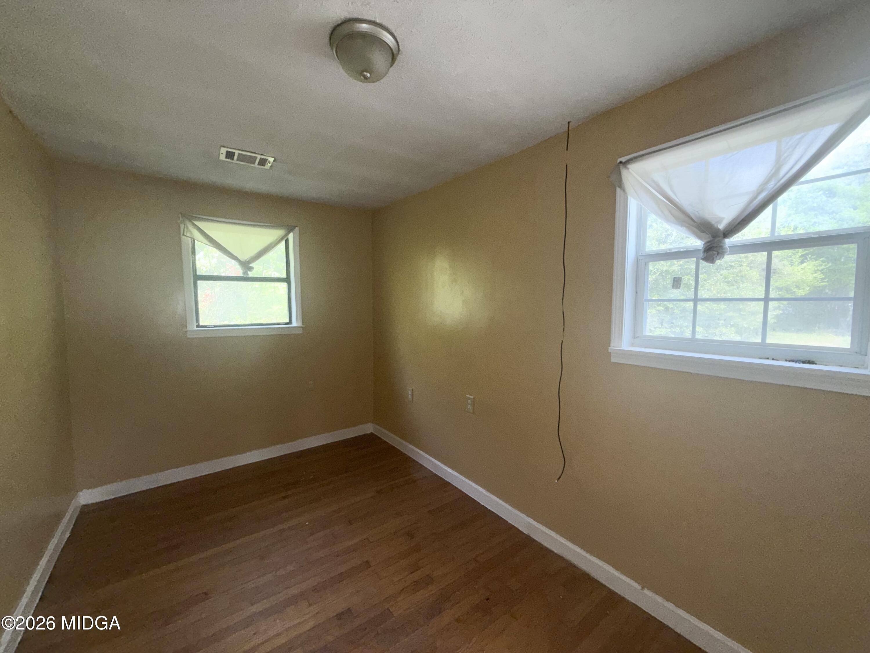 615 Paul Street Macon, GA 31206 - Photo 12 of 24 an empty room with wooden floor and windows