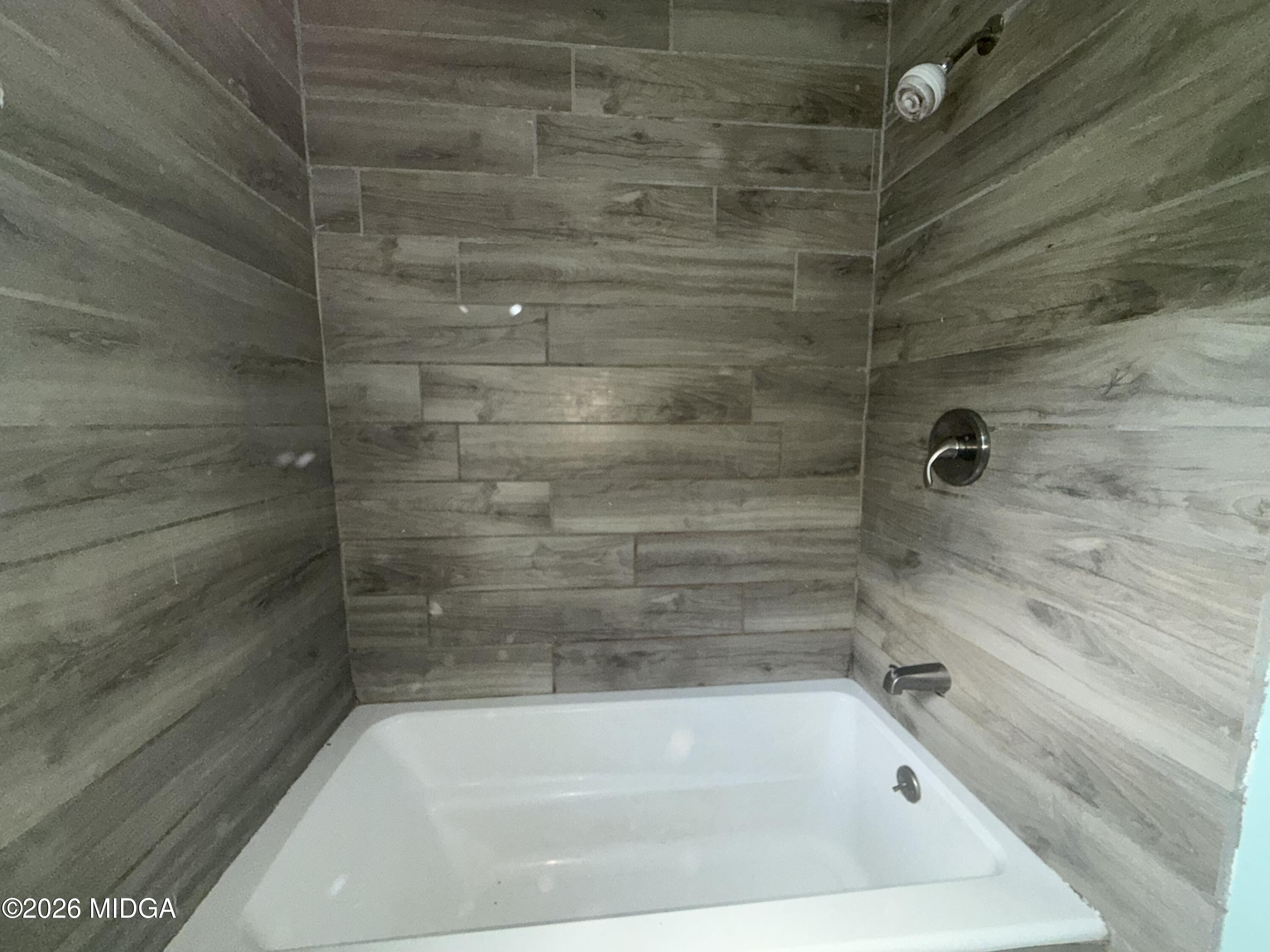 615 Paul Street Macon, GA 31206 - Photo 13 of 24 a close up of a bathtub in a bathroom