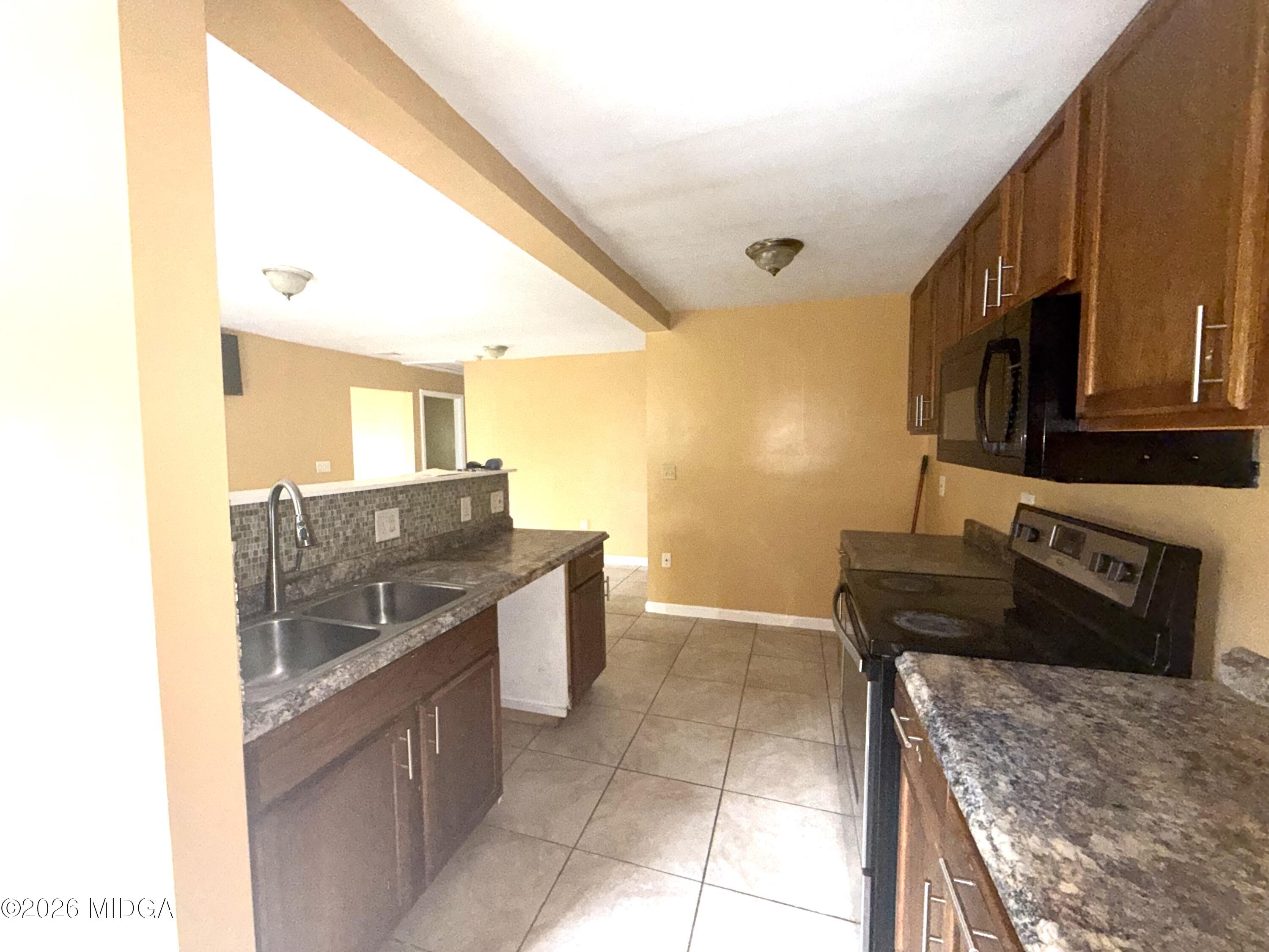 615 Paul Street Macon, GA 31206 - Photo 20 of 24 a kitchen with stainless steel appliances granite countertop a sink and cabinets
