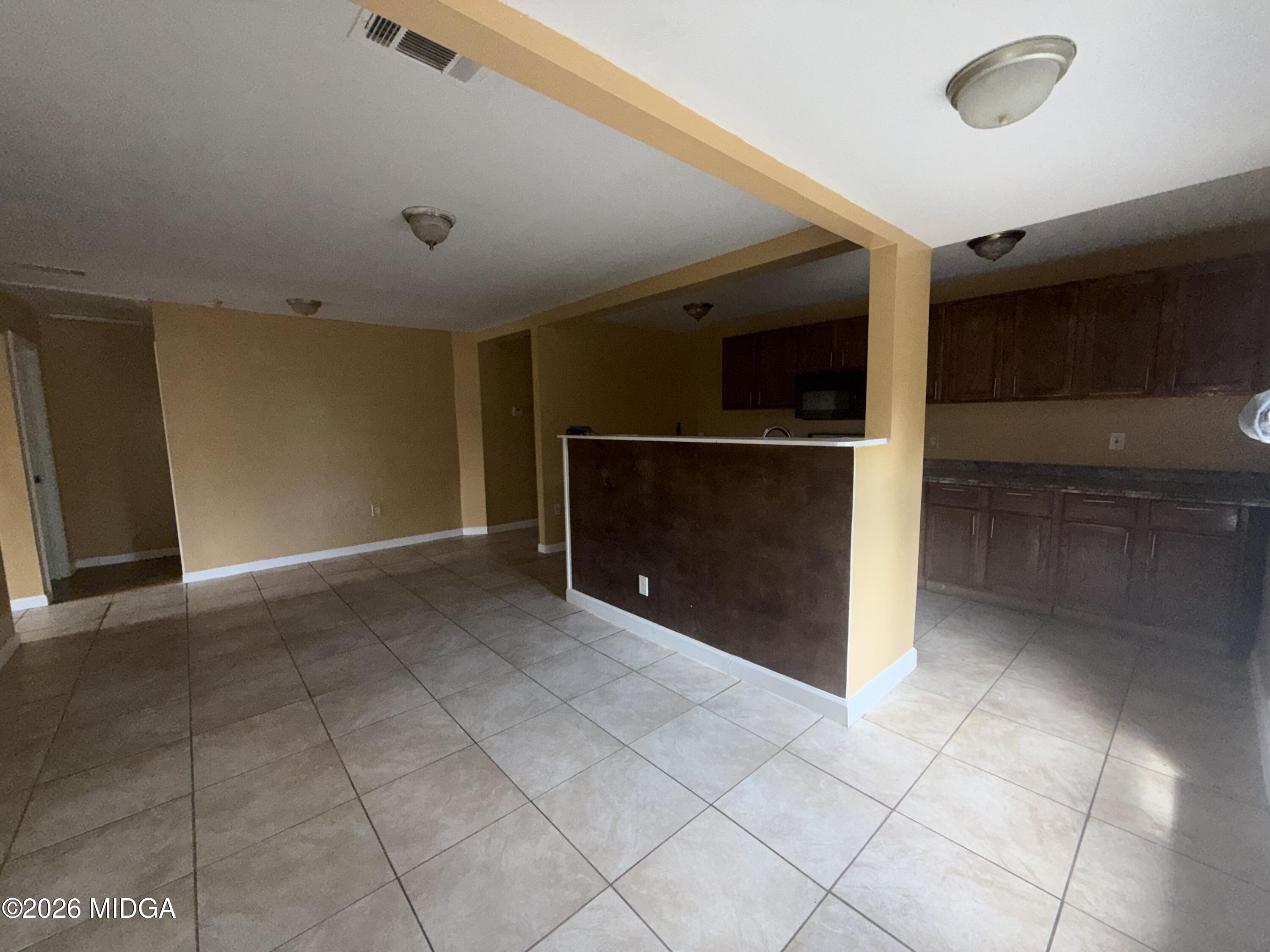 615 Paul Street Macon, GA 31206 - Photo 21 of 24 a view of an empty room with a fireplace and a window