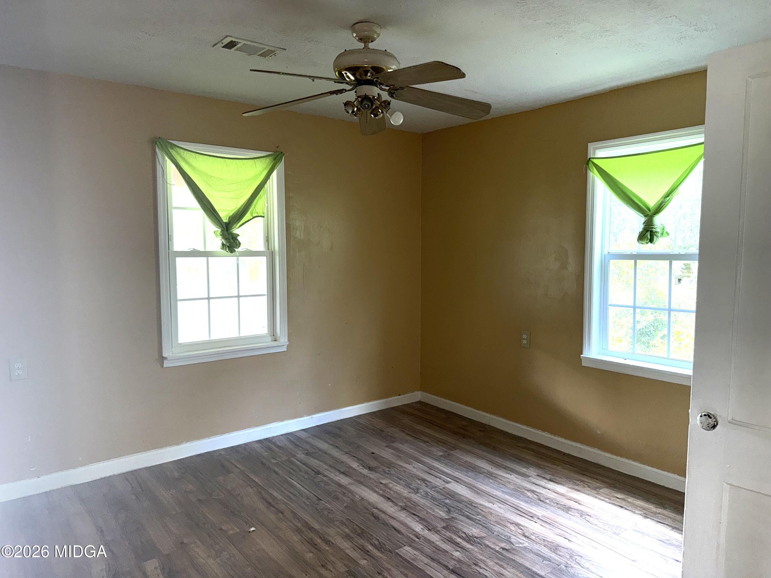 615 Paul Street Macon, GA 31206 - Photo 10 of 24 a view of an empty room with a window and wooden floor