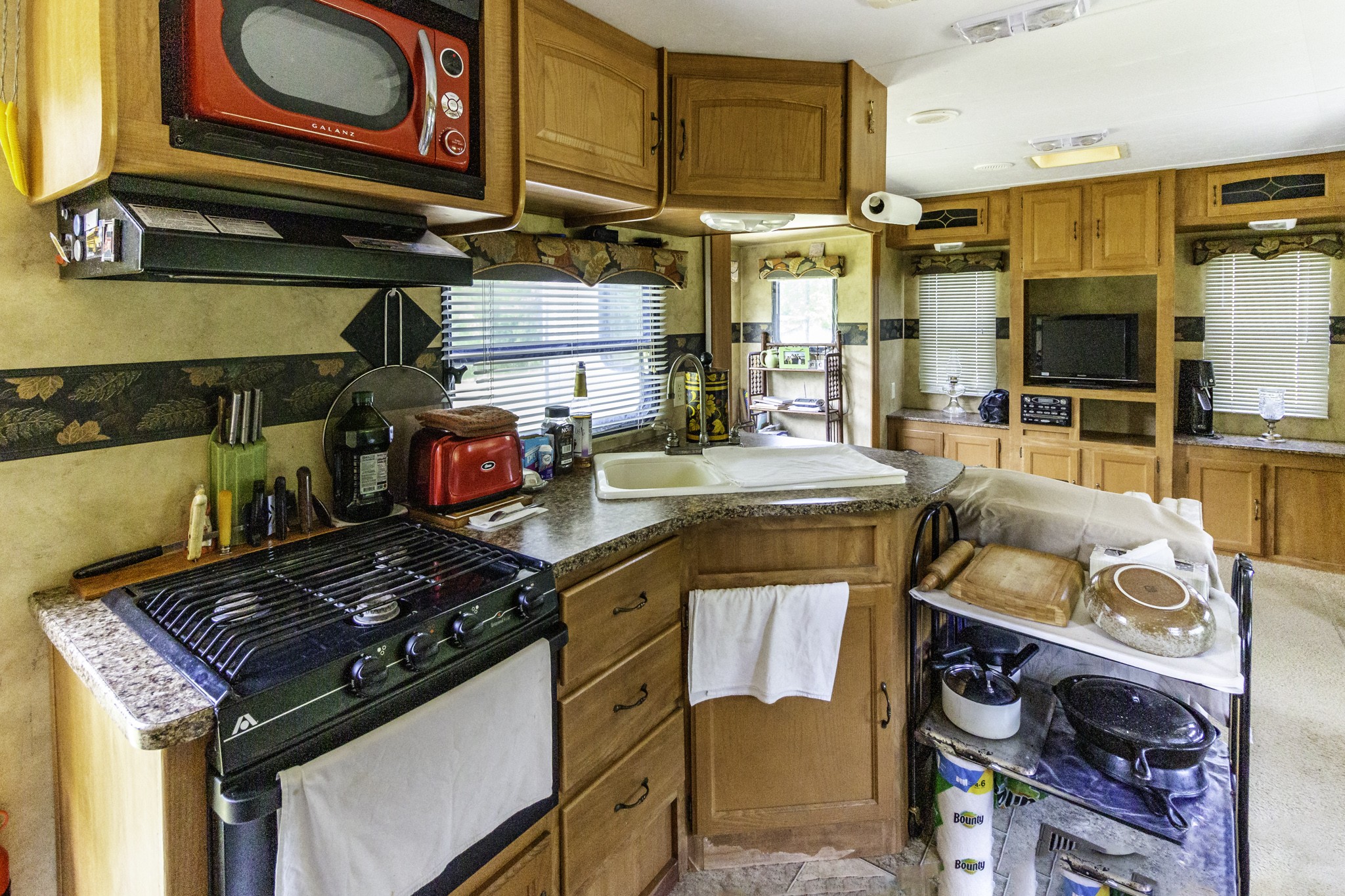 133 Clifton Road Lawrenceburg, TN 38464 - Photo 7 of 27 a kitchen with stainless steel appliances granite countertop a stove and a microwave