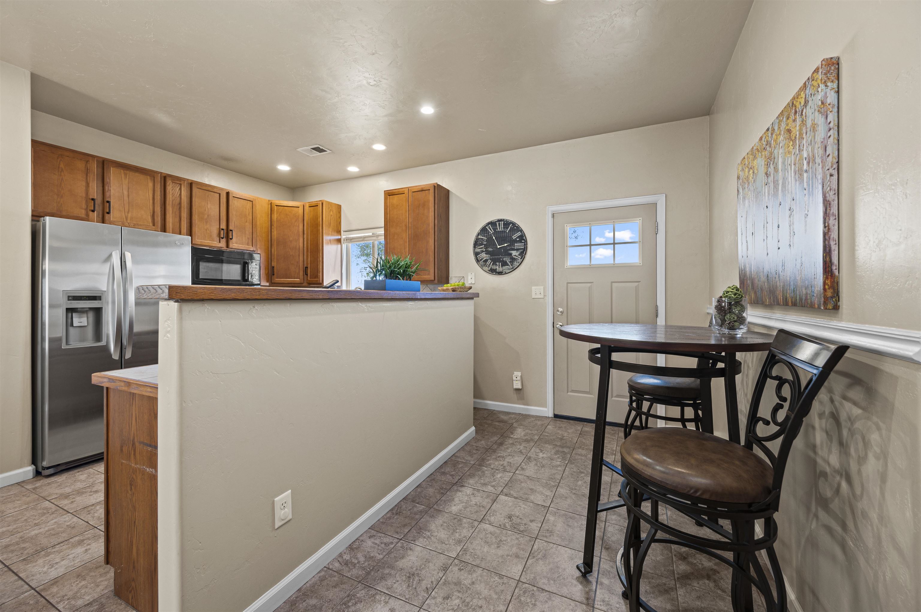 2436 1/2 Jack Creek Road Grand Junction, CO 81505 - Photo 11 of 36 a view of a kitchen with furniture and a refrigerator