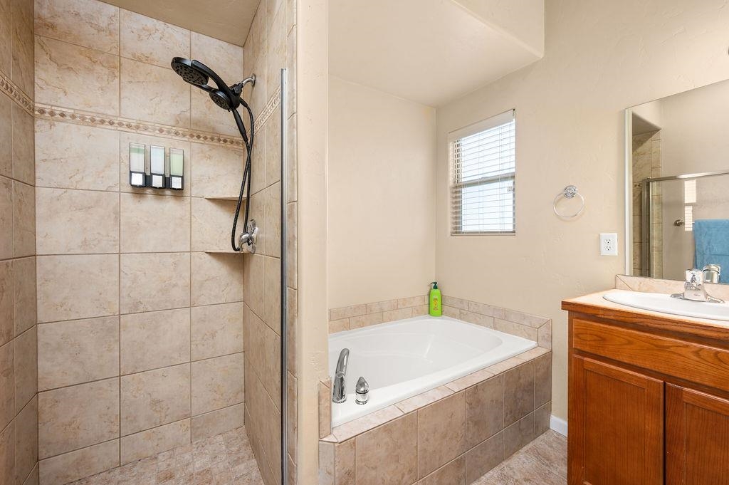 2436 1/2 Jack Creek Road Grand Junction, CO 81505 - Photo 18 of 36 a bathroom with a granite countertop sink a toilet and shower
