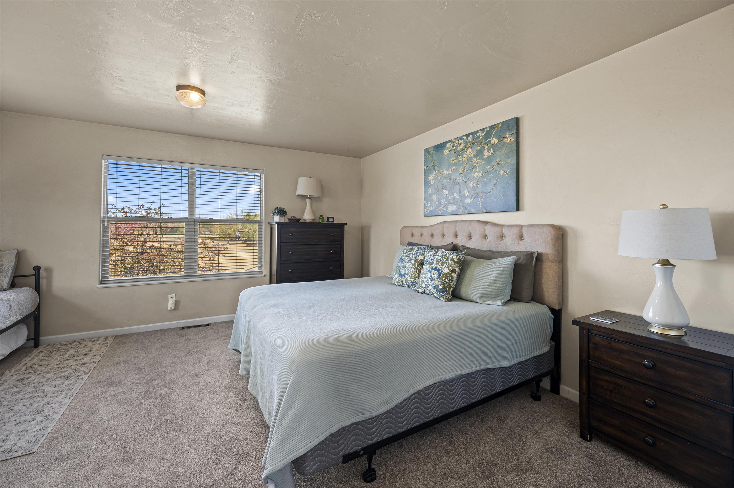 2436 1/2 Jack Creek Road Grand Junction, CO 81505 - Photo 20 of 36 a bedroom with a bed and a window